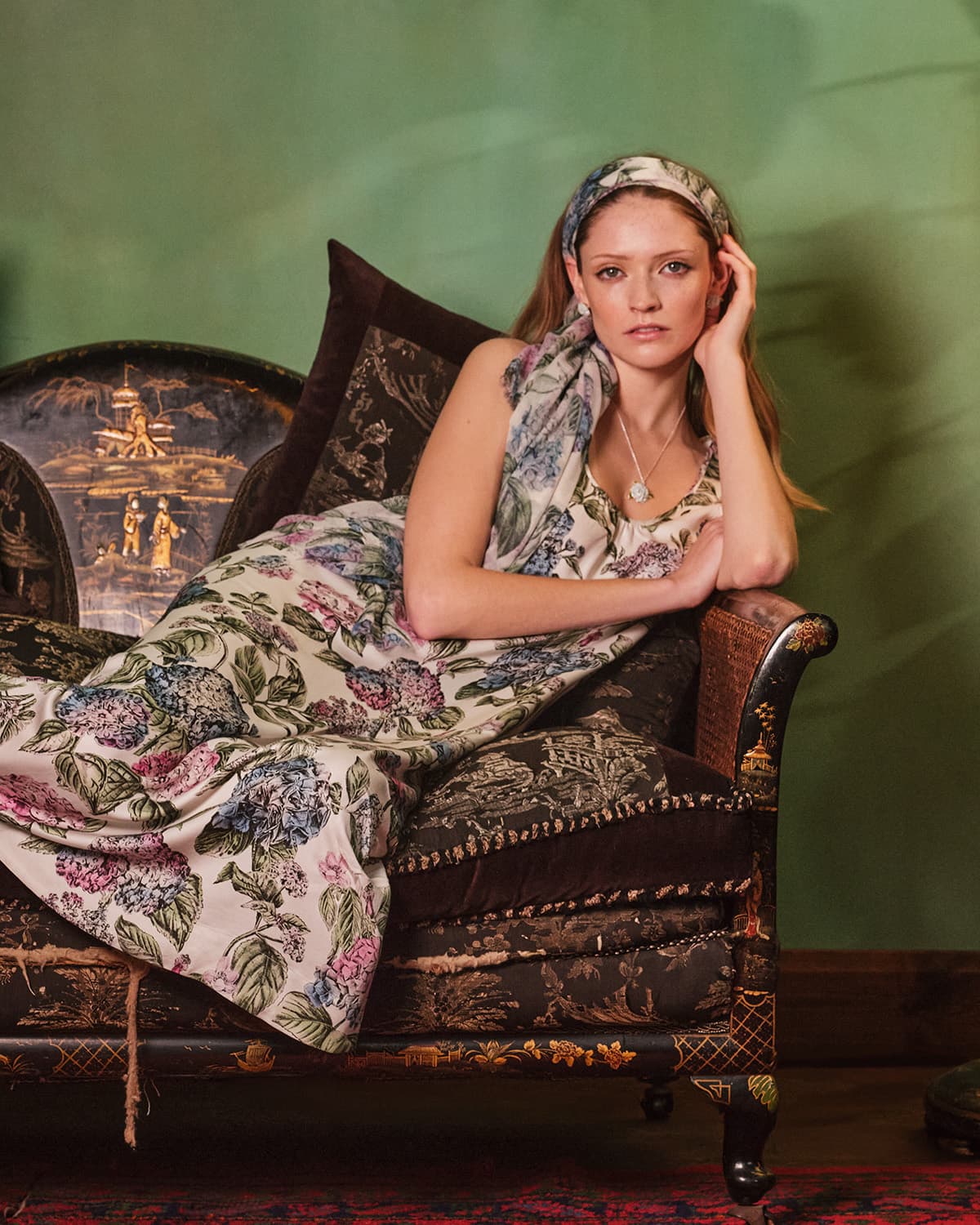 A woman in a Fable England print, on a sofa
