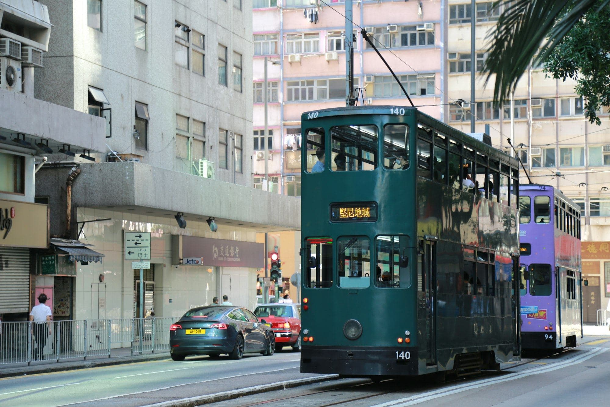 A Hong Kong double-decker tram waiting at a stop