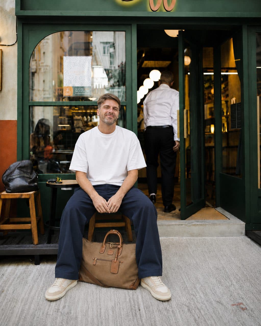 Matt Naughton, founder of Naughton & Bird, seated outside a coffee shop in Hong Kong