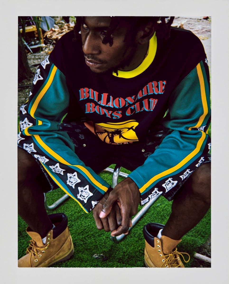 A Billionaire Boys Club tracksuit top, seated