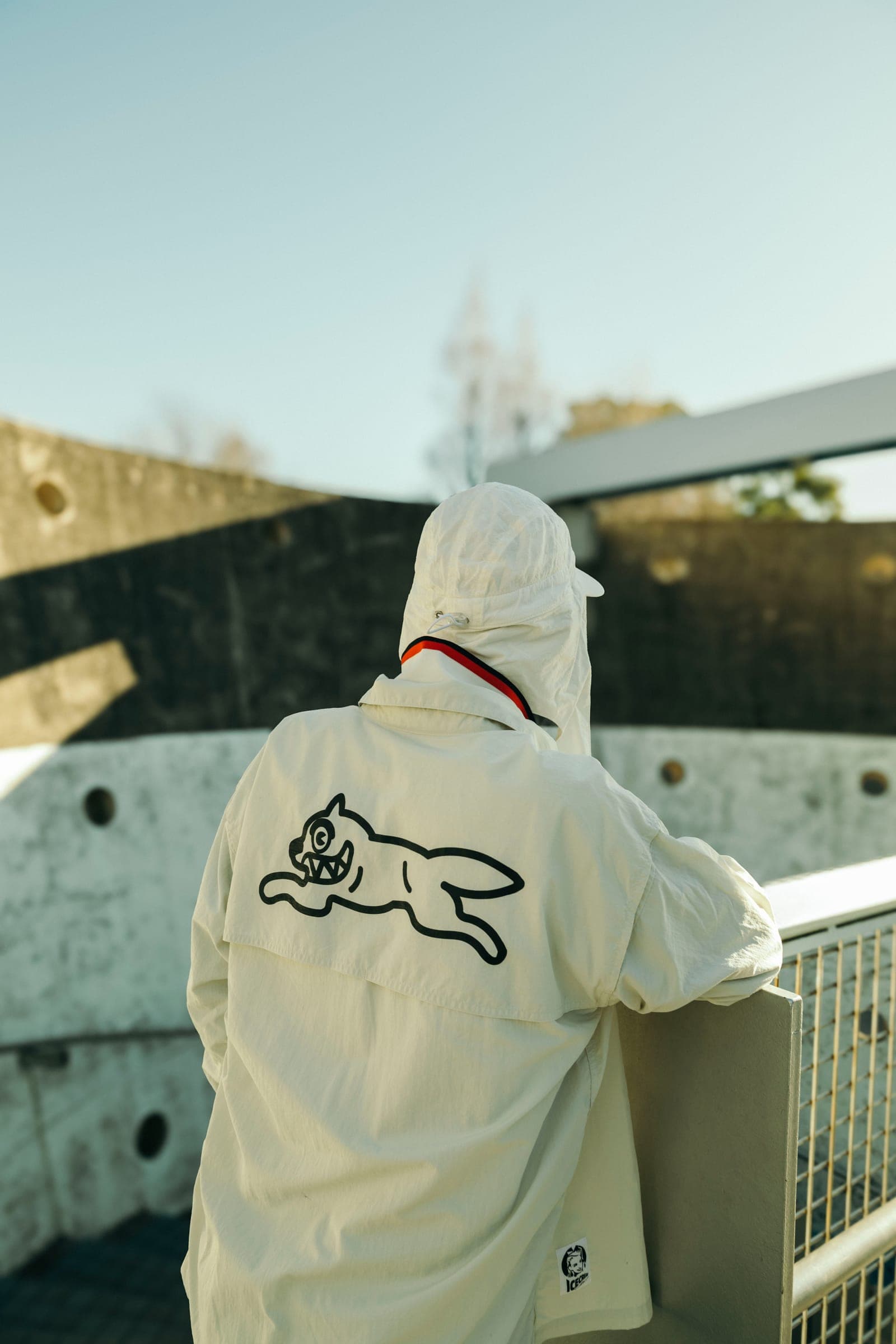 A white ICECREAM jacket on a bridge