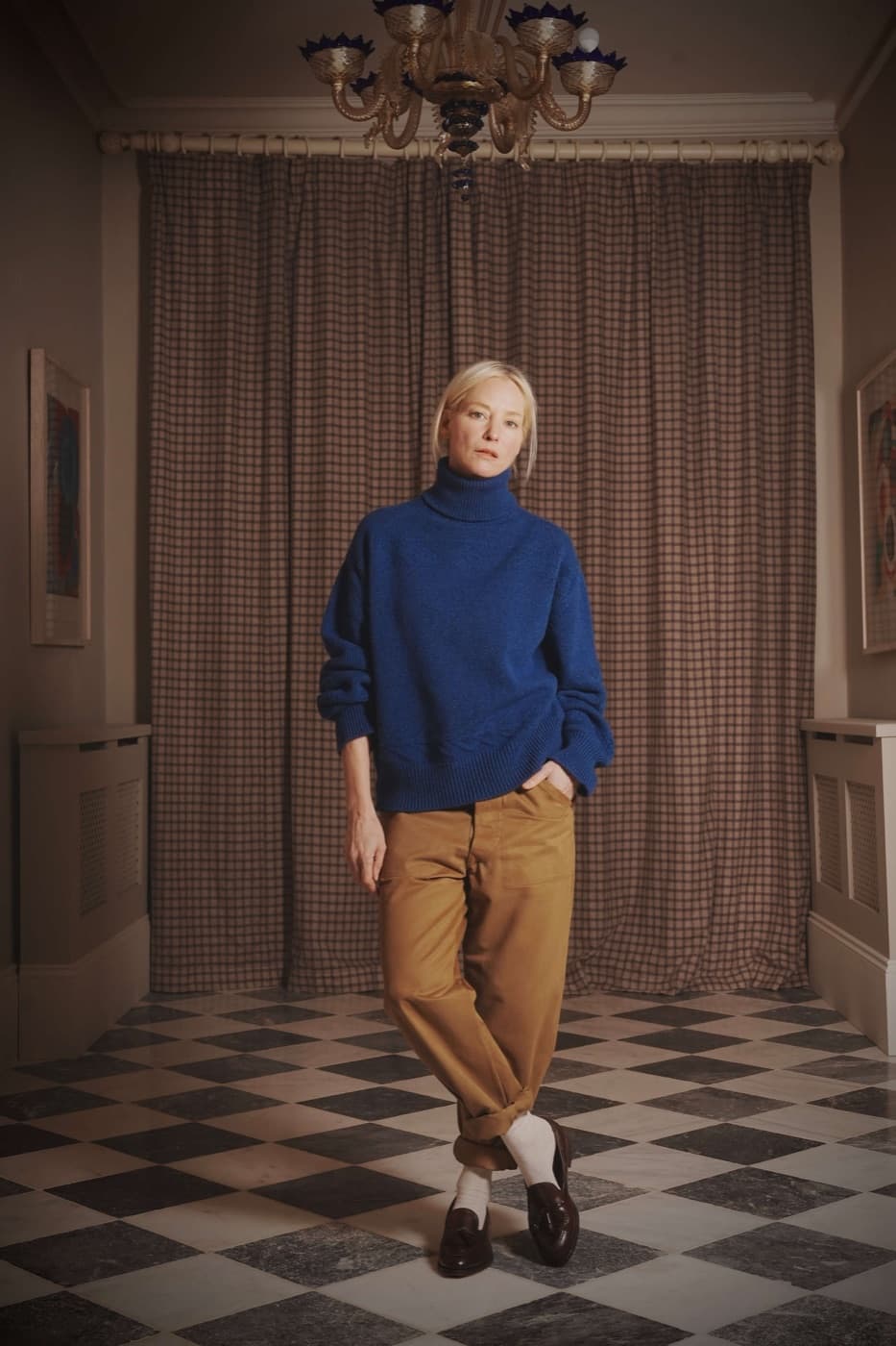 A model in a Carrier Company blue turtleneck jumper and corduroy trousers