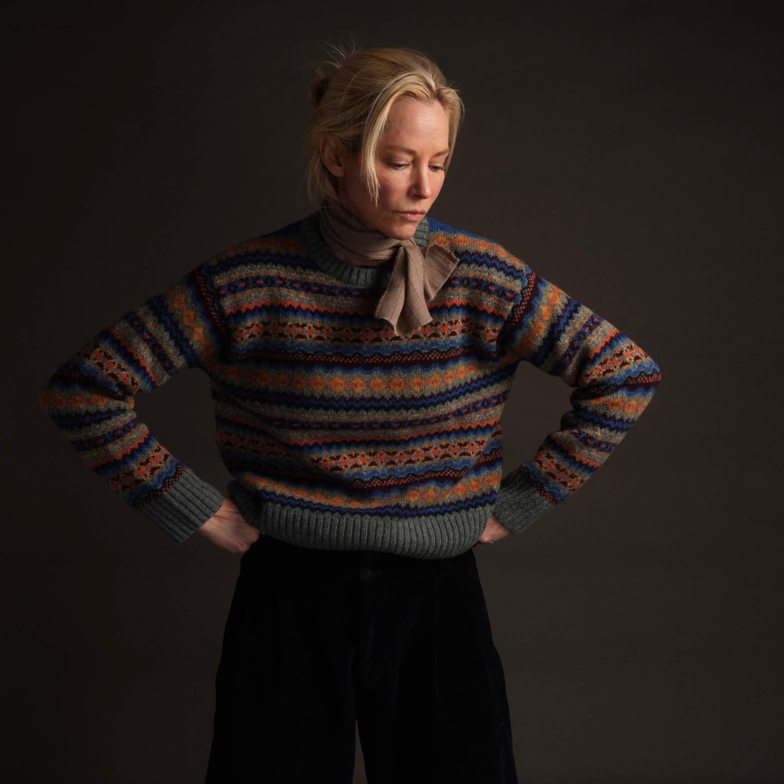 A model wearing a Carrier Company Fair Isle knit jumper, studio portrait