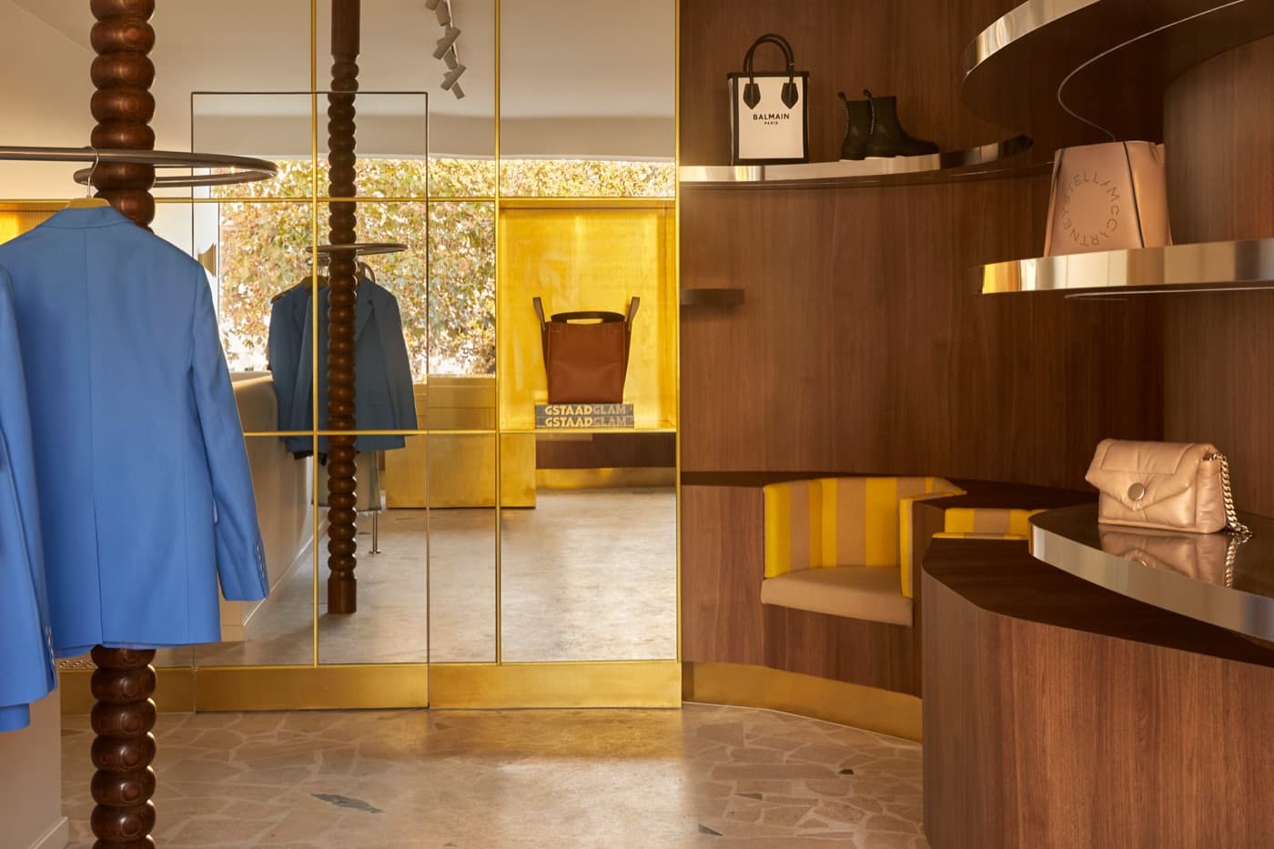 A tailored jacket on the rail beside the mirrored gold nook at Grace Brighton