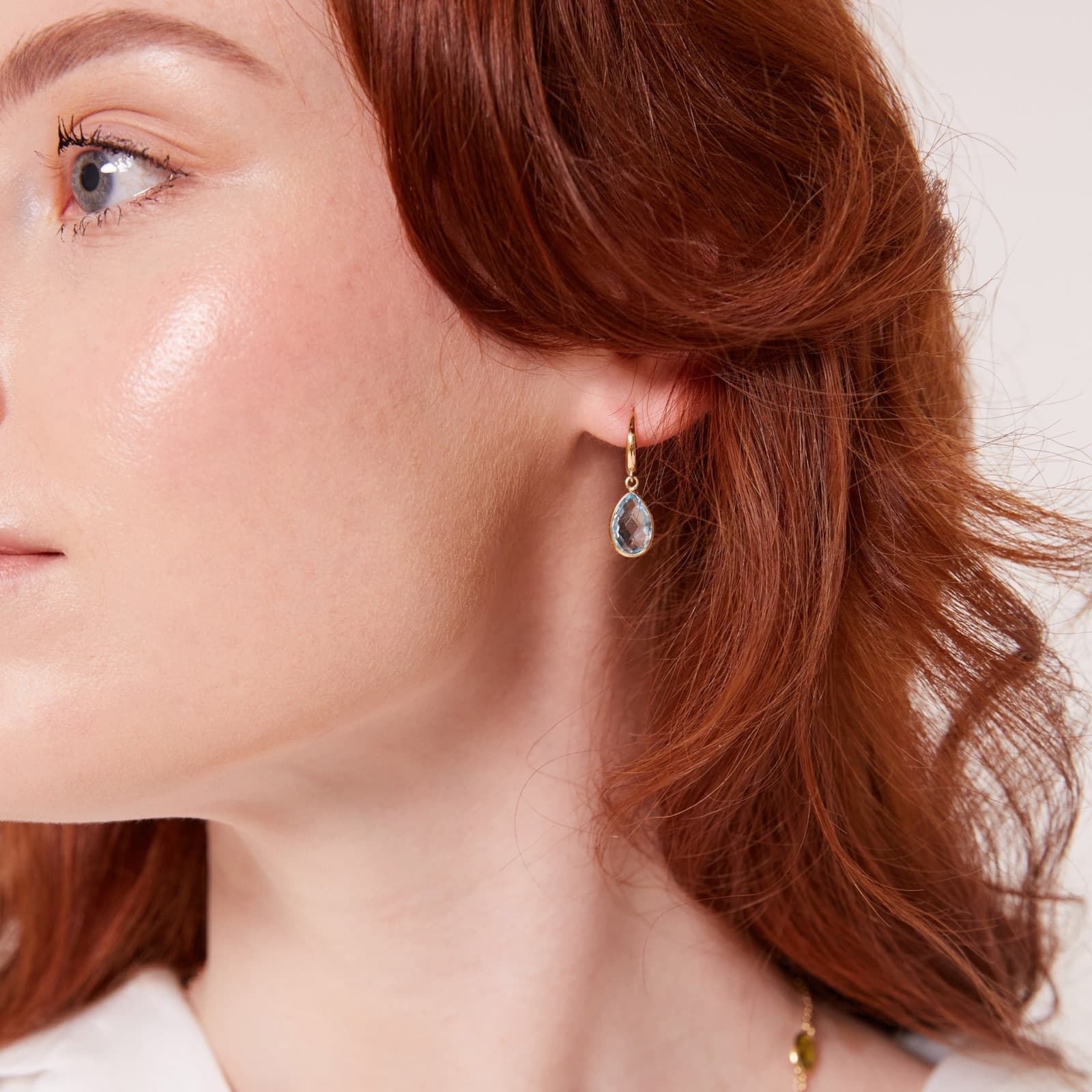 A Kiki McDonough blue topaz drop earring, worn
