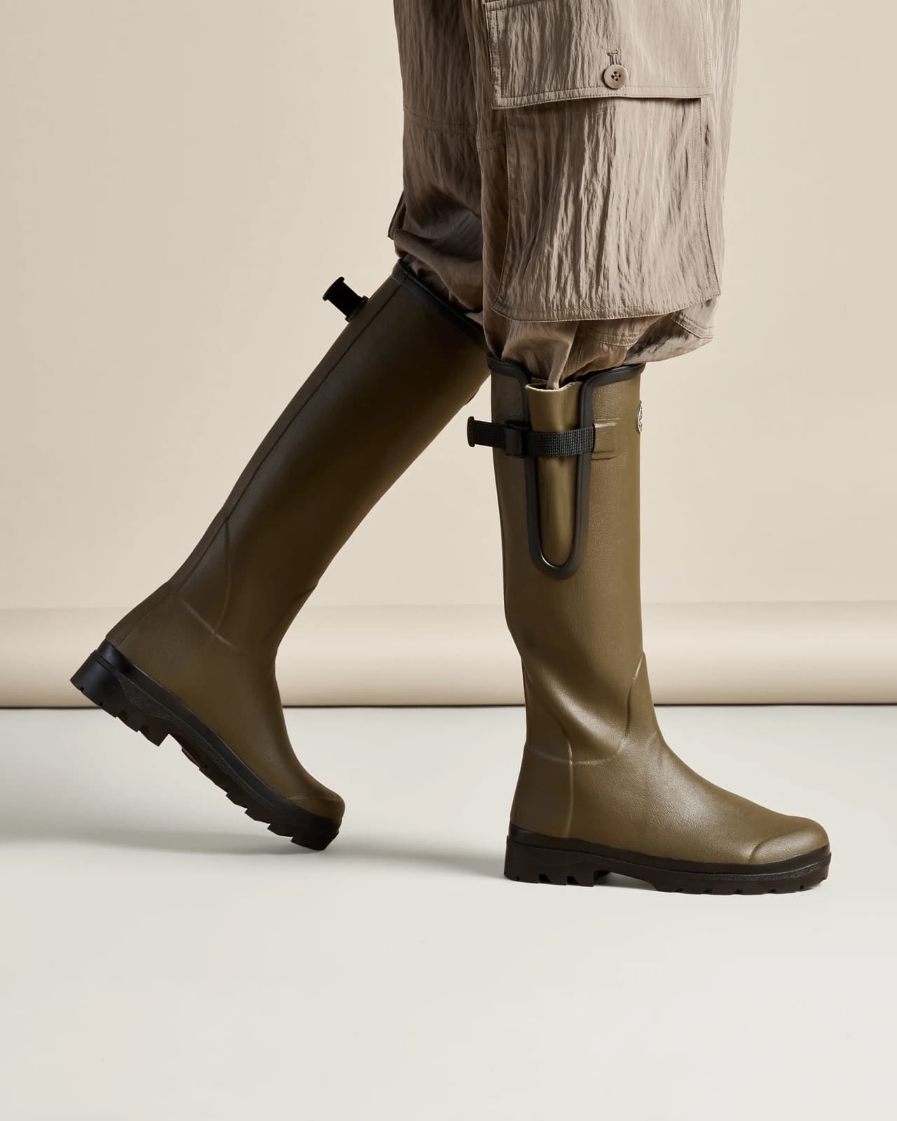 Le Chameau wellington boots worn mid-stride against a cream studio backdrop