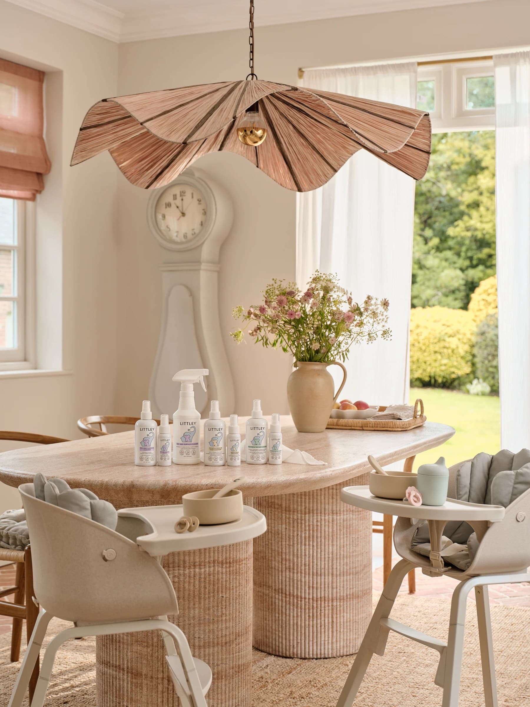 The Littley range laid out on a family dining table between two baby high chairs