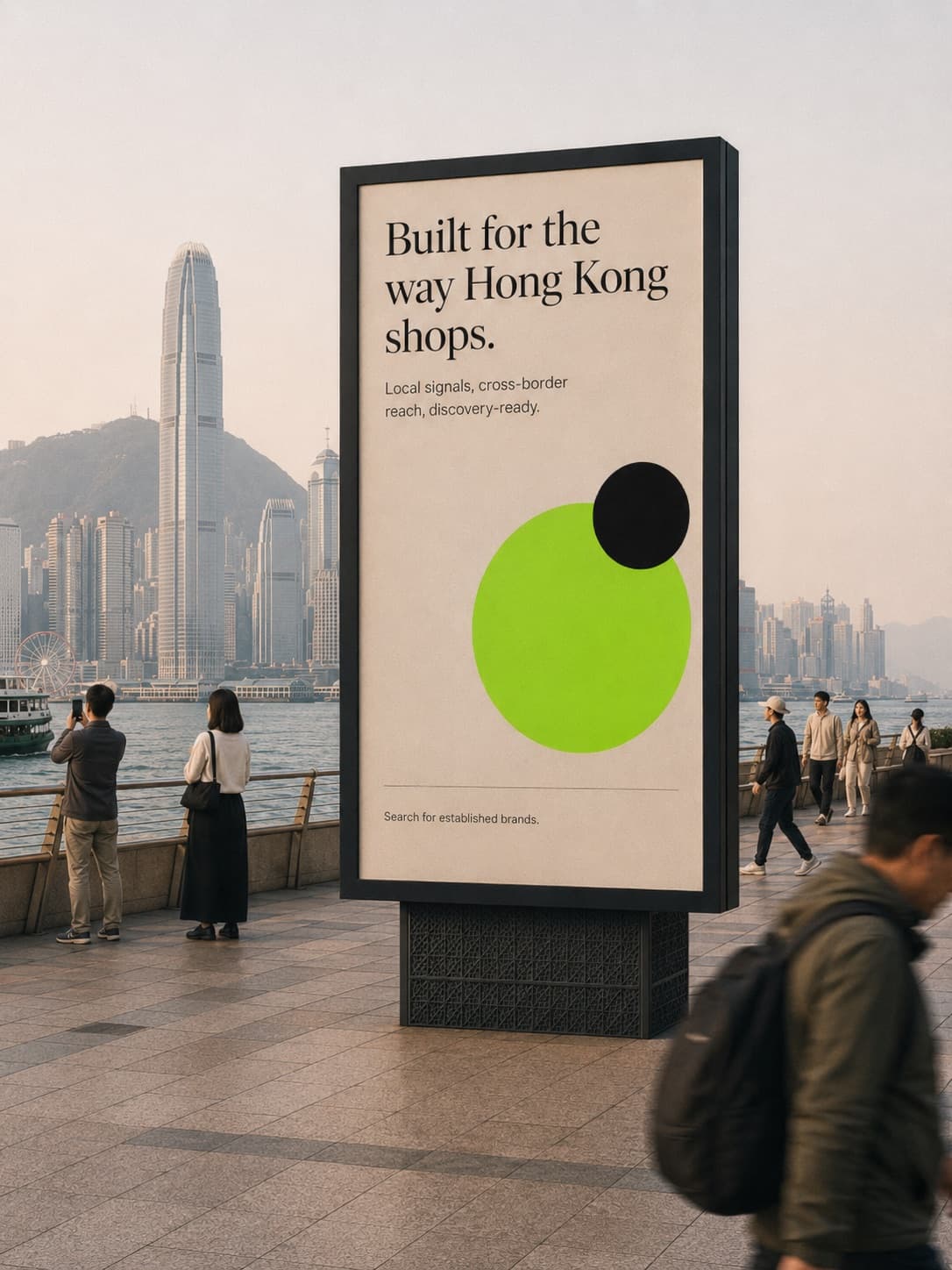 A billboard on the Tsim Sha Tsui promenade reading Built for the way Hong Kong shops, the Central skyline across the harbour