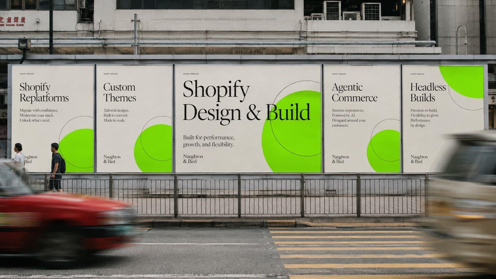 Naughton & Bird Shopify design and build billboards on a Hong Kong street as a red taxi passes