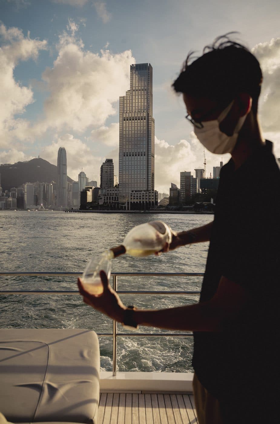 A glass poured on deck against the Hong Kong skyline
